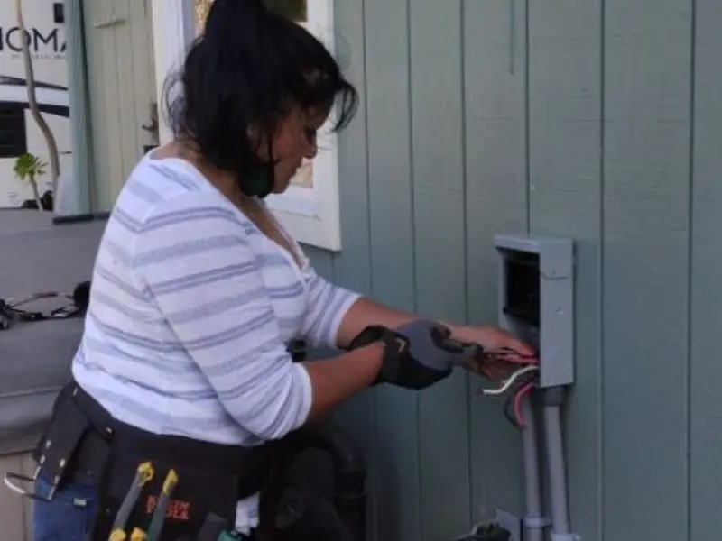 Licensed electrician wiring an exterior subpanel in Peru