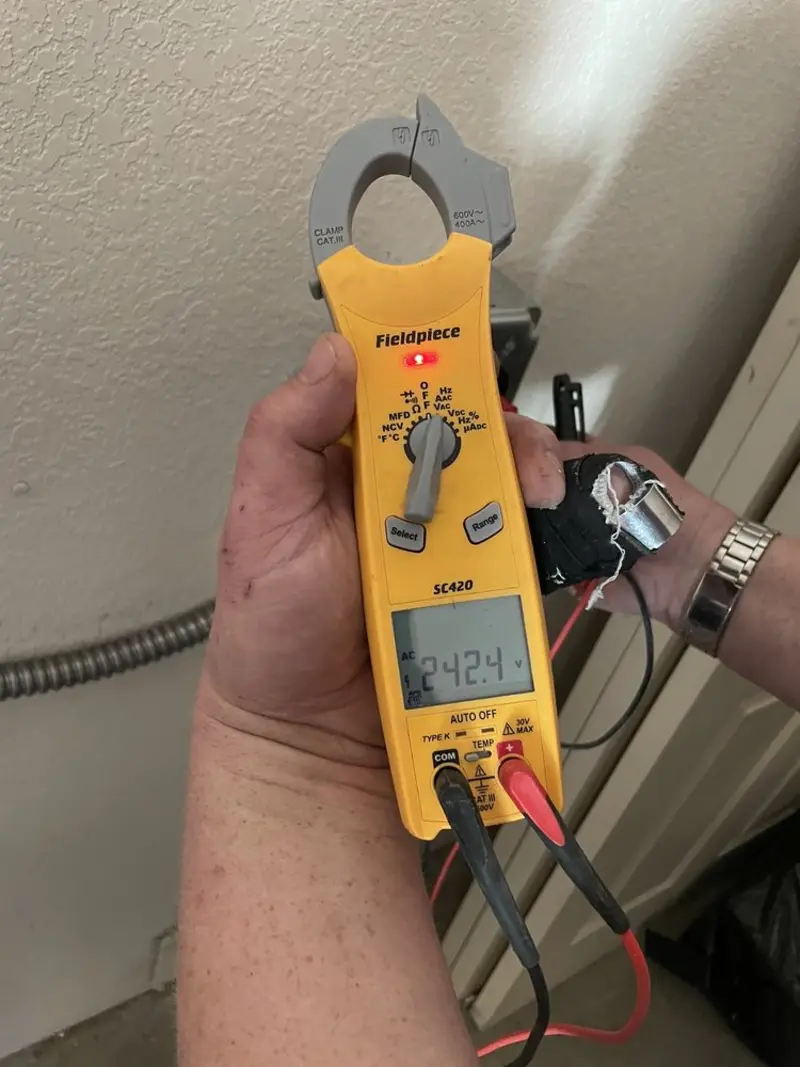 Voltage testing with clamp meter during Whole House Surge Protector in Peru